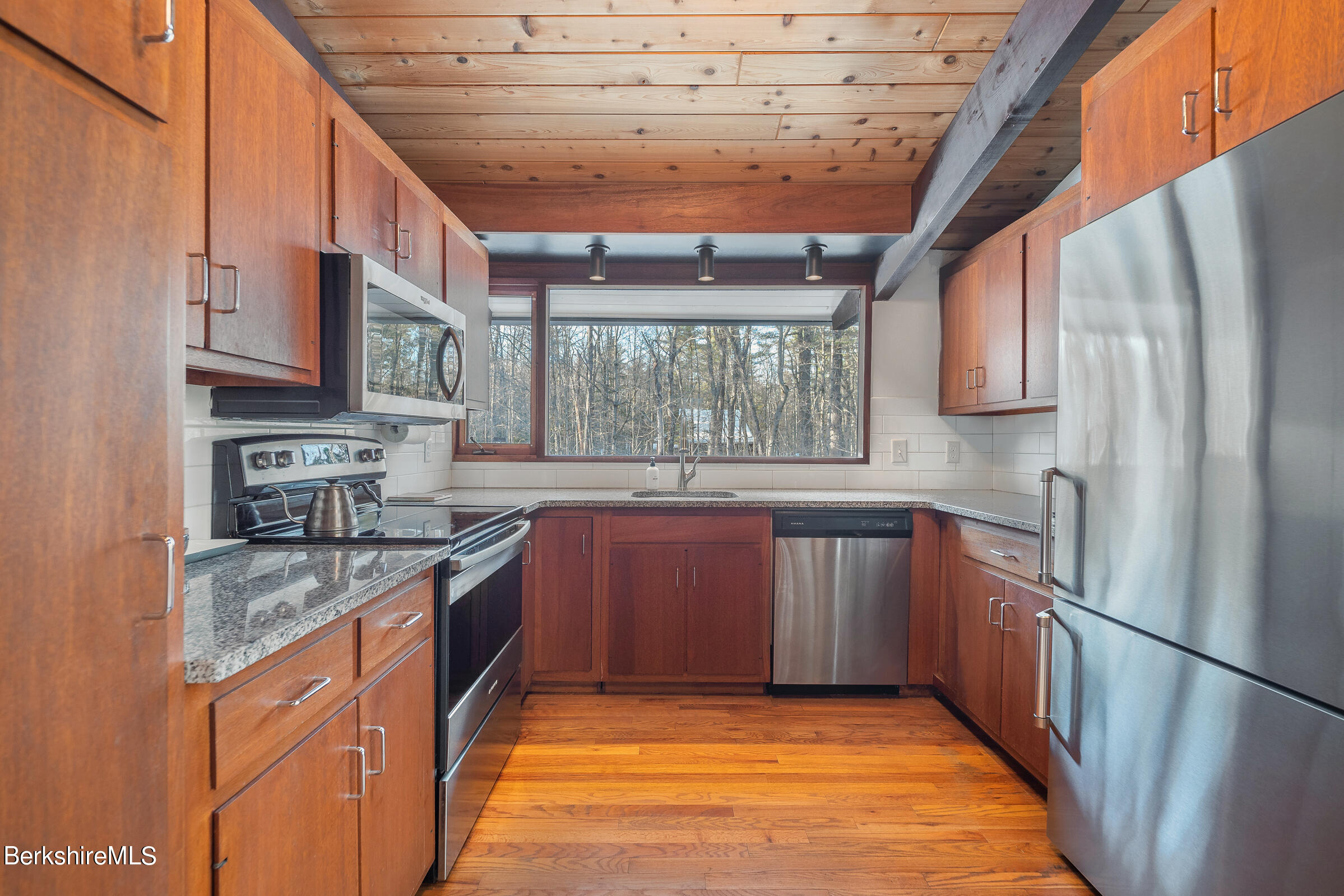 176 Beech Tree Lane Becket, MA 01223 - Photo 15 of 44 a kitchen with stainless steel appliances granite countertop a refrigerator a sink dishwasher a stove and white countertops with wooden floor
