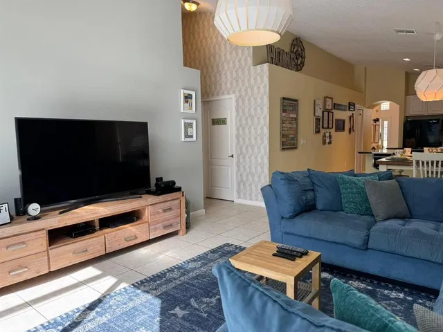 a living room with furniture a rug and a large window