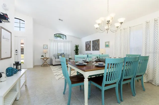 a view of a dining room with furniture and chandelier
