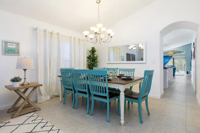 a view of a dining room with furniture and chandelier