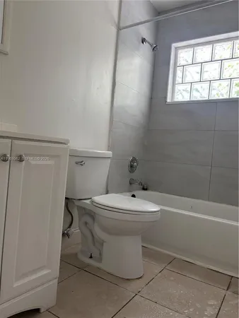a bathroom with a sink a toilet and tub