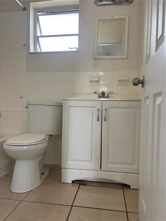 a view of a big yard with plants and large trees