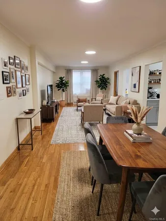 a living room with dining room and wooden floor