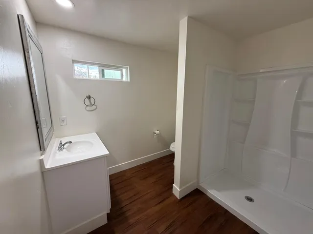 a bathroom with a sink toilet and shower