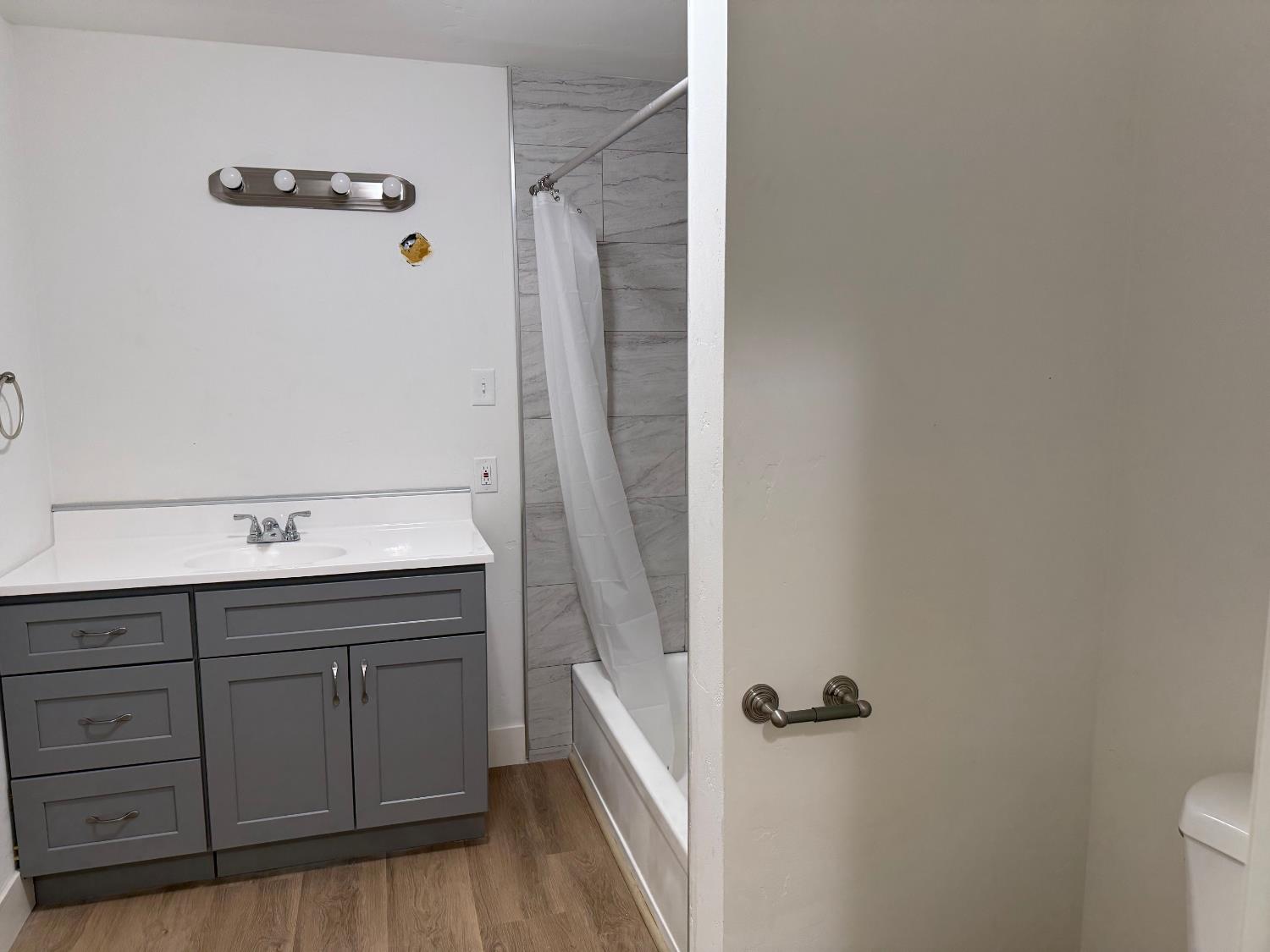 548 East Pleasant Street Coalinga, CA 93210 - Photo 16 of 18 a bathroom with a sink and mirror