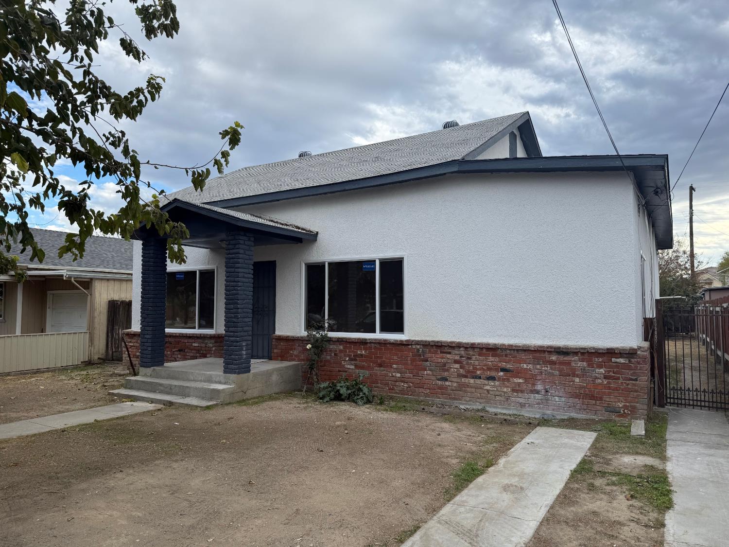 548 East Pleasant Street Coalinga, CA 93210 - Photo 2 of 18 a front view of a house with a road