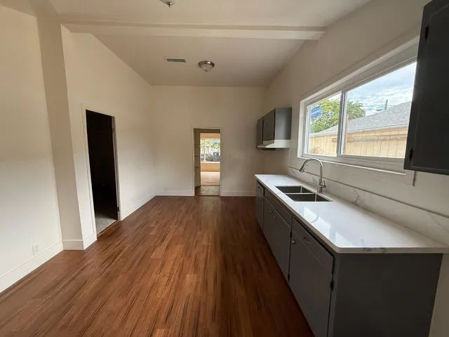 a kitchen with a sink and large window