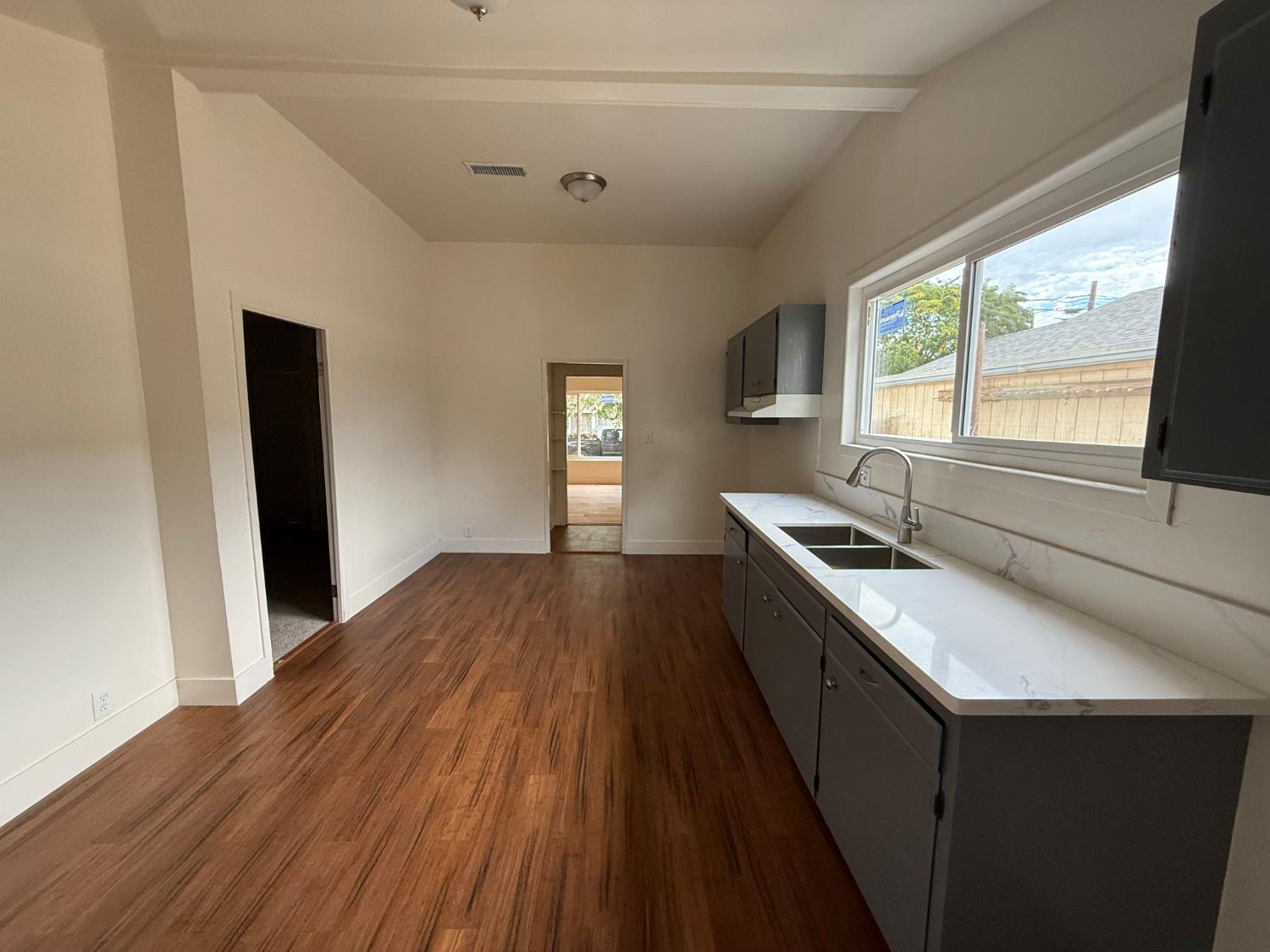 548 East Pleasant Street Coalinga, CA 93210 - Photo 3 of 18 a kitchen with a sink and large window