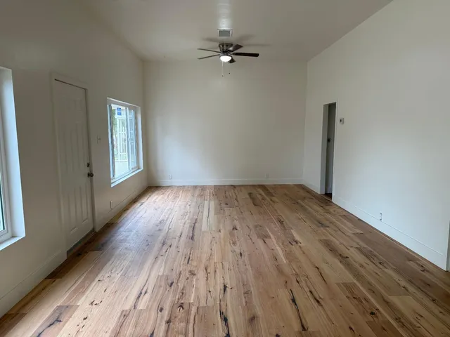 wooden floor in an empty room with a window
