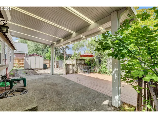 a view of a patio with furniture and garden