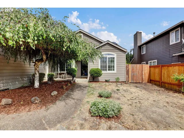 a backyard of a house with table and chairs