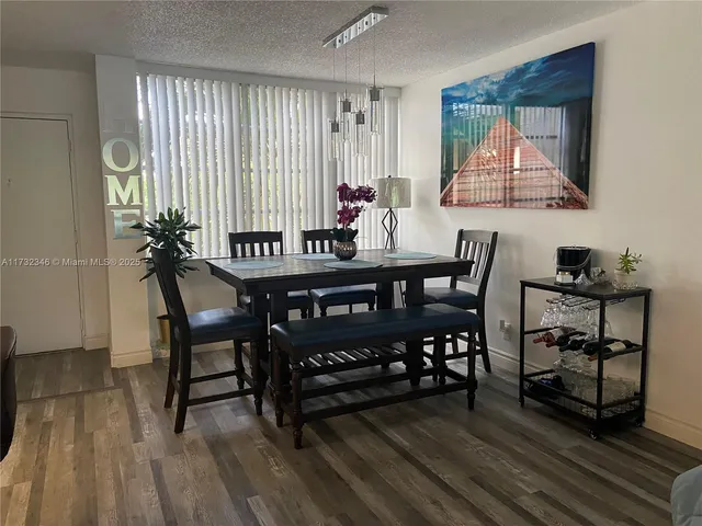 a view of a dining room with furniture and window