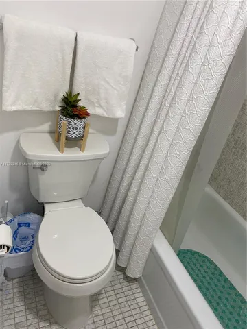 a bathroom with a toilet and a bathtub