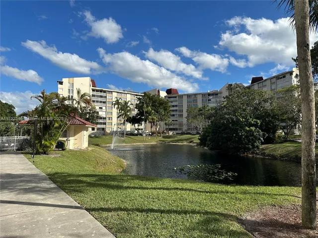 a room with lots of furniture and view of kitchen