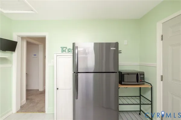 a white refrigerator freezer and a stove sitting inside of a kitchen