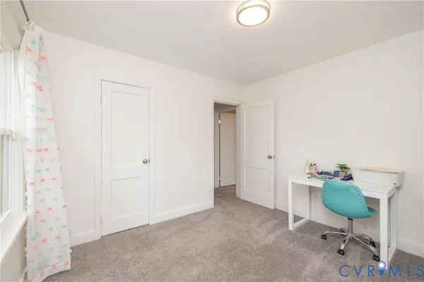 a workspace with furniture and a bathroom