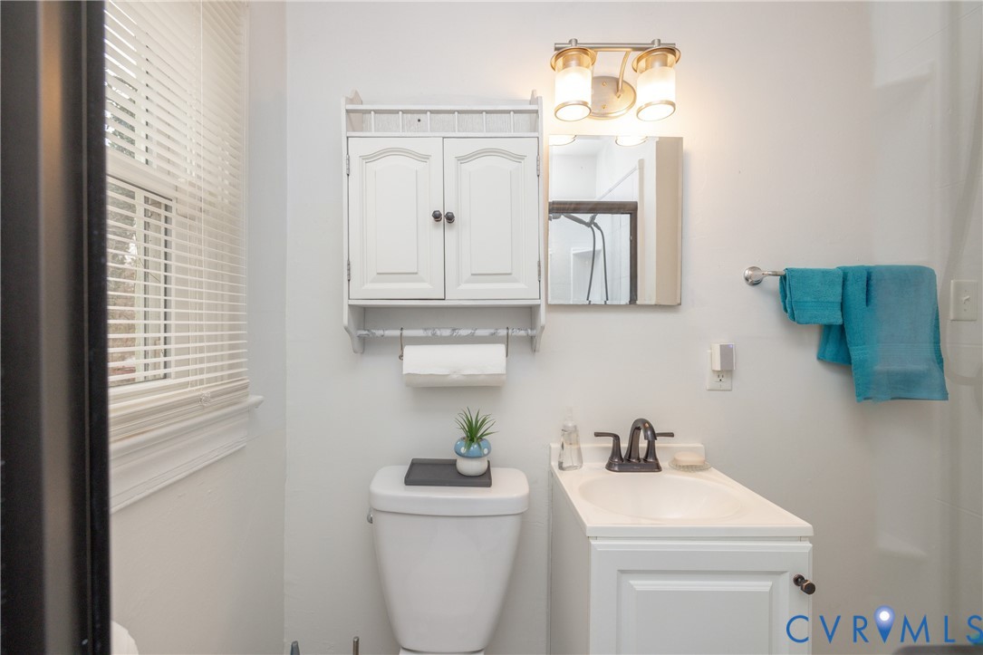 2904 Bethlehem Road Henrico, VA 23228 - Photo 15 of 22 a bathroom with a toilet a sink and a mirror
