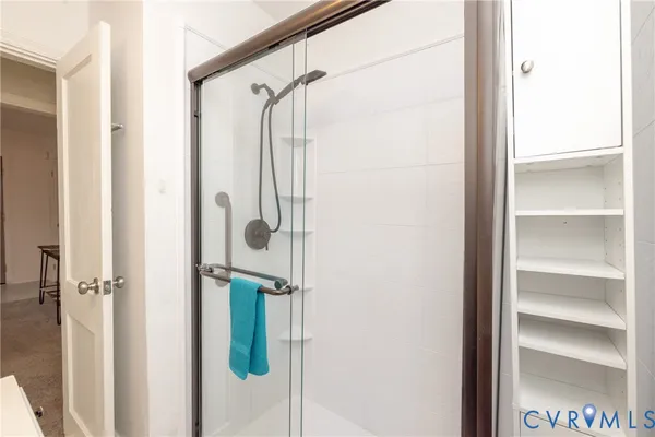 a bathroom with a glass shower door