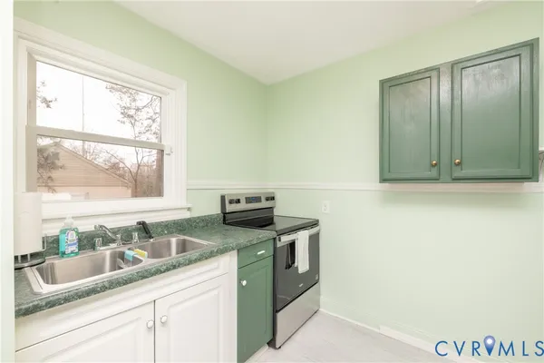 a kitchen with granite countertop cabinets stainless steel appliances and a sink