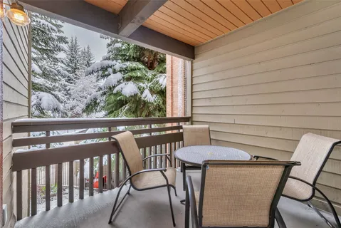 a view of a chairs and table in the balcony