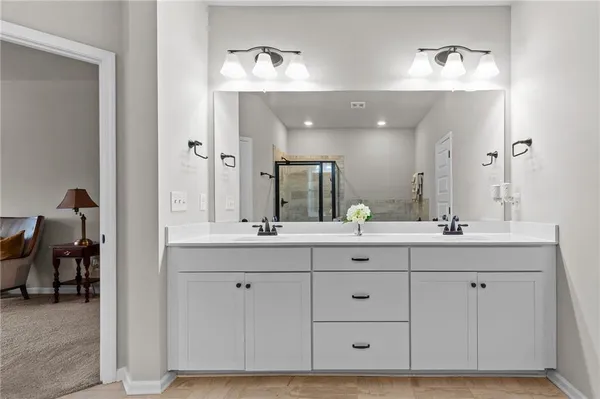 a bathroom with a double vanity sink and a mirror