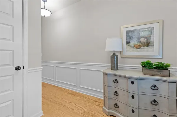 a view of hallway with window and wooden floor