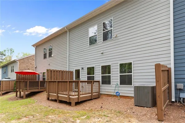 a backyard of a house with barbeque oven table and chairs