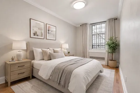 a bedroom with a bed and a window
