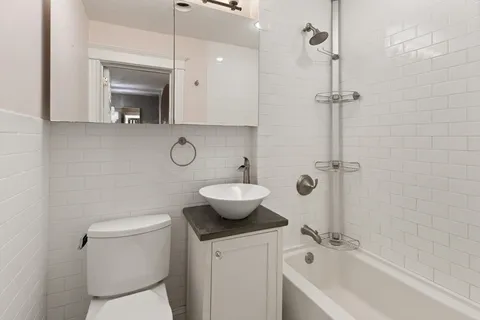 a bathroom with a toilet a sink and a mirror