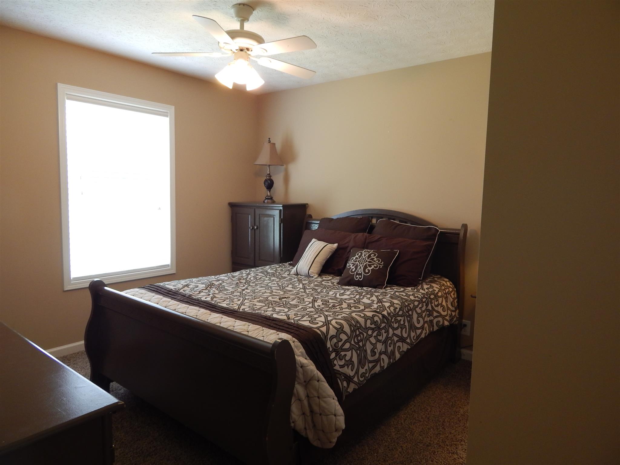 1533 Rapids Road Portland, TN 37148 - Photo 12 of 17 a bedroom with a bed and a chandelier