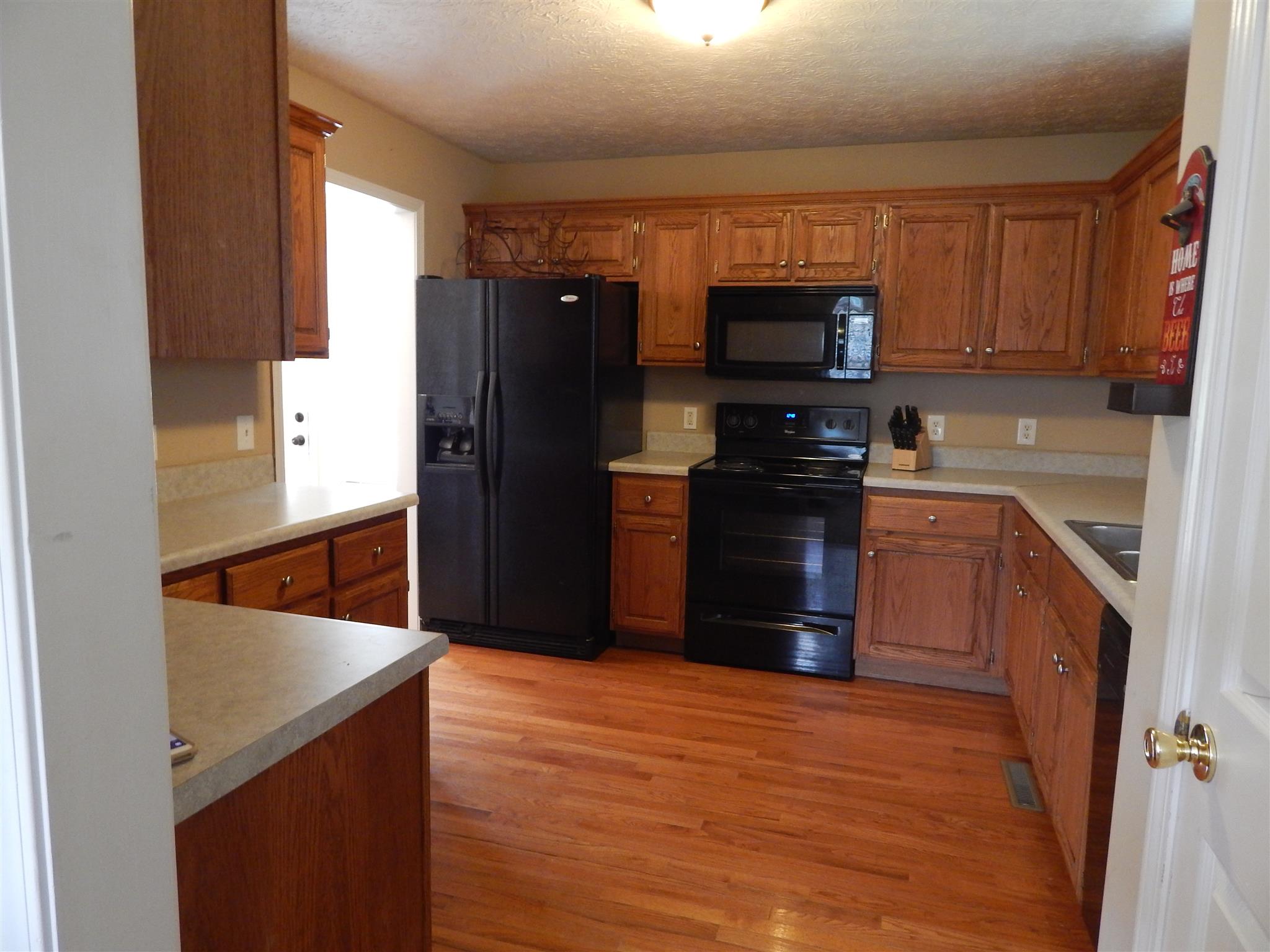 1533 Rapids Road Portland, TN 37148 - Photo 7 of 17 a kitchen with stainless steel appliances granite countertop a refrigerator stove and sink