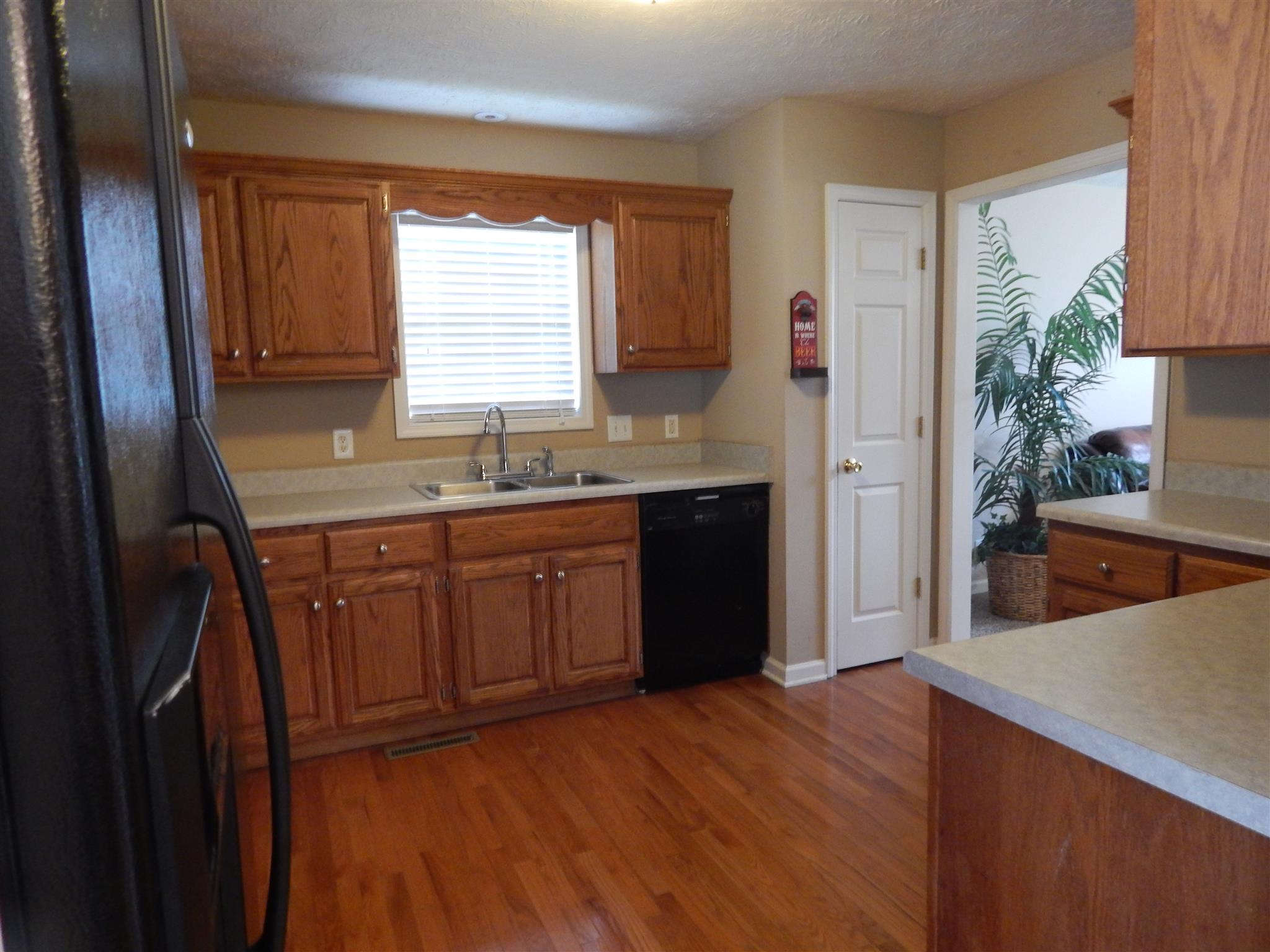 1533 Rapids Road Portland, TN 37148 - Photo 8 of 17 a kitchen with stainless steel appliances granite countertop a sink a stove a refrigerator and wooden cabinets