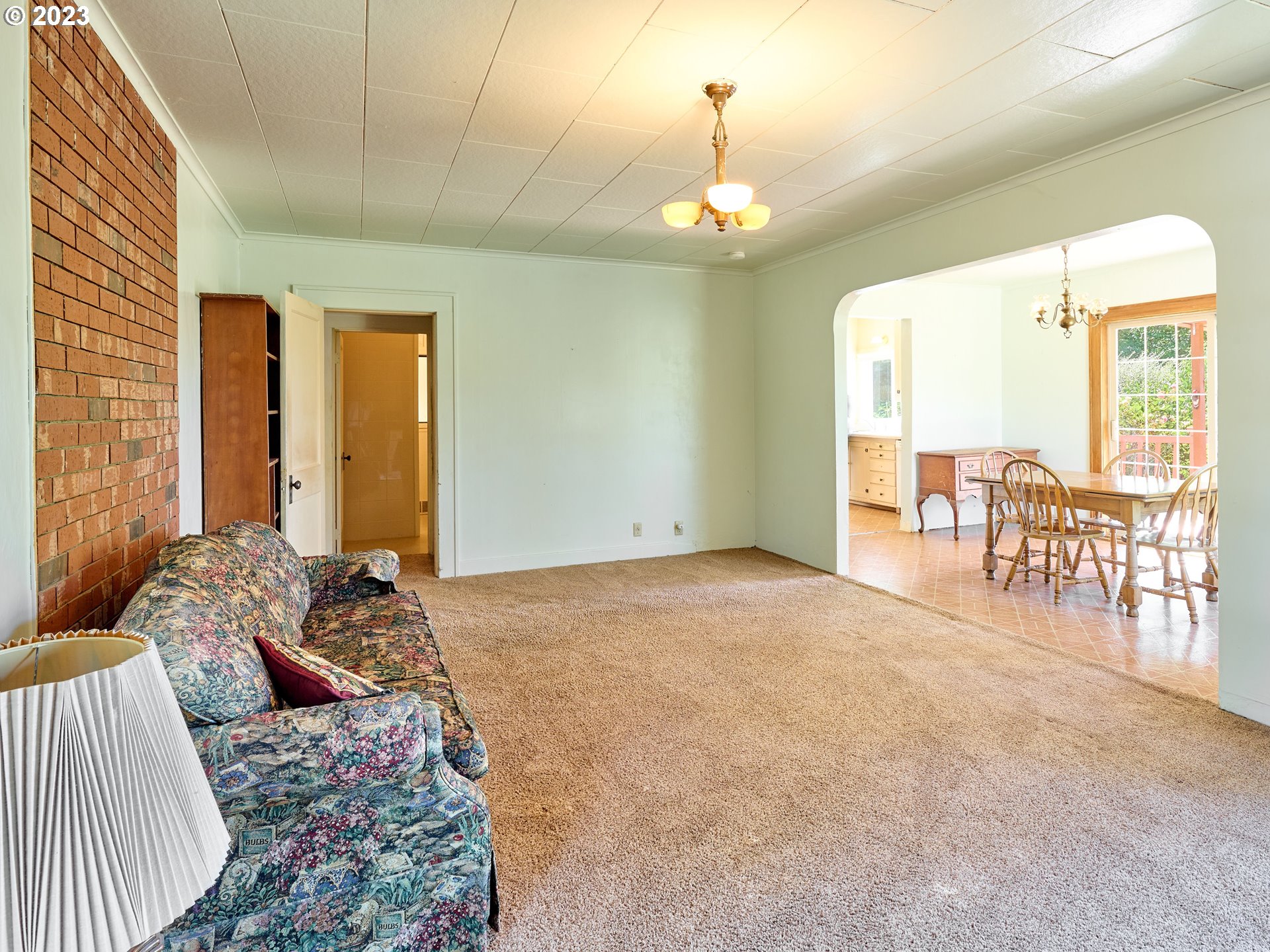 20140 Northeast Dopp Road Newberg, OR 97132 - Photo 21 of 46 a spacious bedroom with a bed and a chandelier