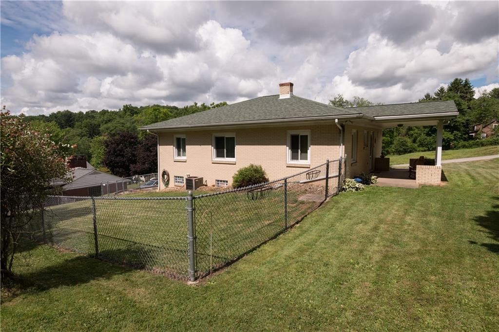 13 Weber Road Jeannette, PA 15644 - Photo 4 of 19 View of the fenced yard and concrete side porch. Great space to gather with family & friends.
