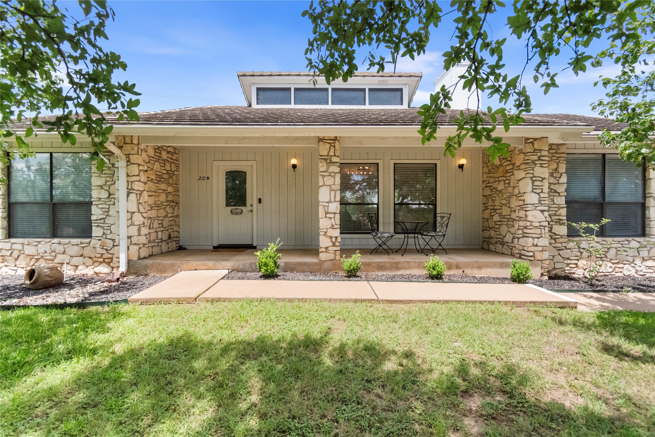 210 Teeoff, Unit B Horseshoe Bay, TX 78657 - Photo 4 of 38 A charming facade with a blend of stone and siding offers inviting curb appeal.