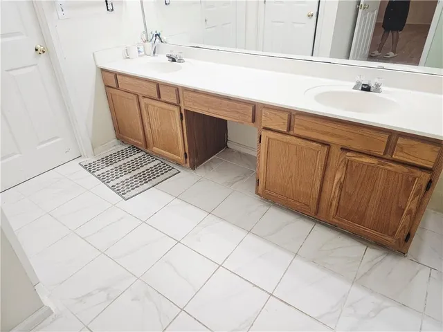 a bathroom with a sink a vanity and a mirror