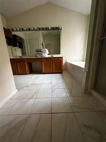 a bathroom with a bathtub and a window