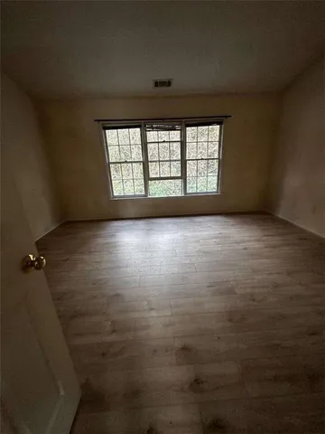 a view of a small space with wooden floor