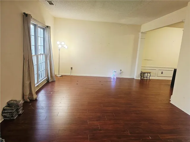 a view of a room with wooden floor