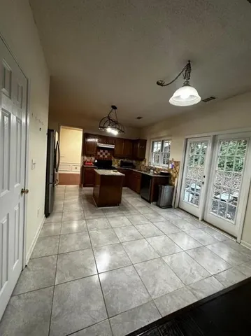 a kitchen with furniture and window