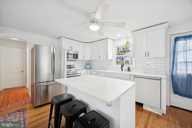 a kitchen with a refrigerator a sink and cabinets
