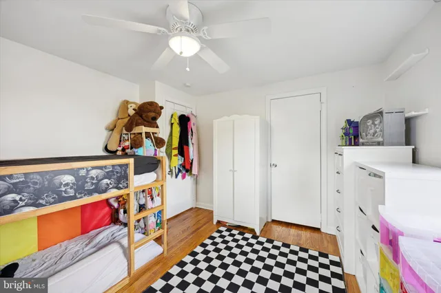a bedroom with furniture and a chandelier fan