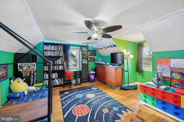 a bedroom with a bed bookshelf and a window