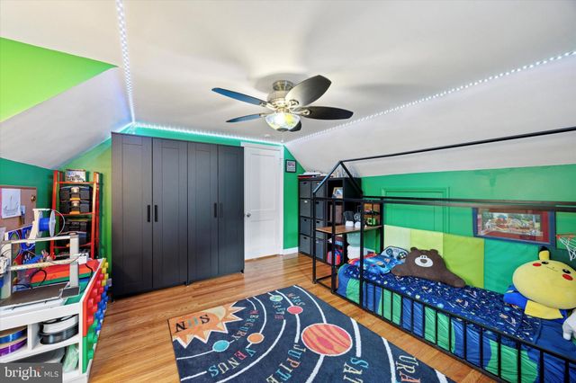 a living room with lots of furniture and baby bed