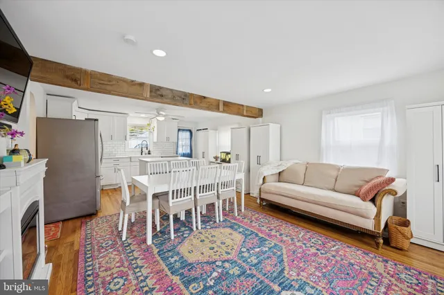 a living room with furniture a rug and a piano