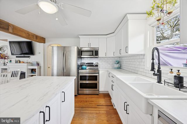 a kitchen with stainless steel appliances a stove sink microwave and cabinets