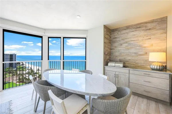 a large kitchen with kitchen island a sink table and chairs
