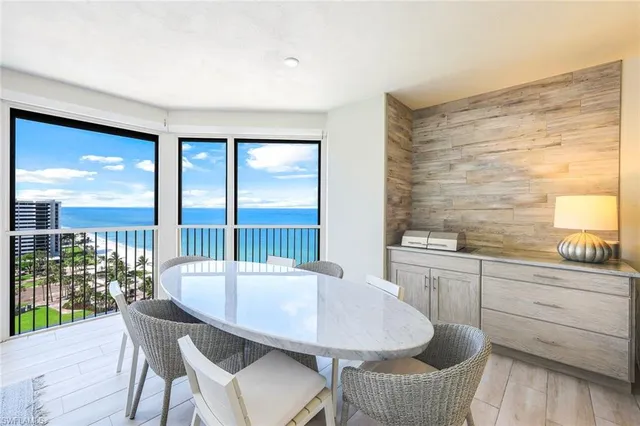 a large kitchen with kitchen island a sink table and chairs