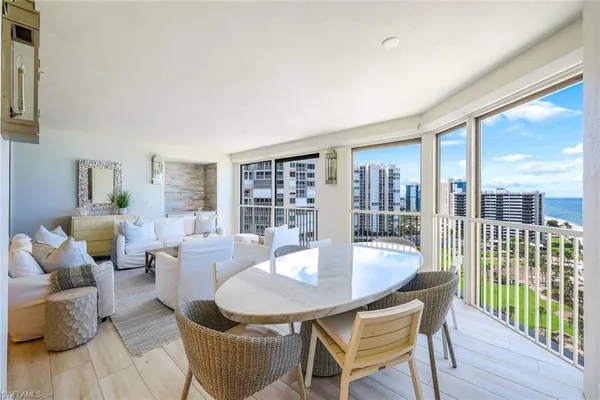 a kitchen with a sink a stove a refrigerator cabinets and dining table