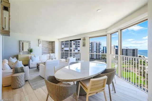 a kitchen with a sink a stove a refrigerator cabinets and dining table